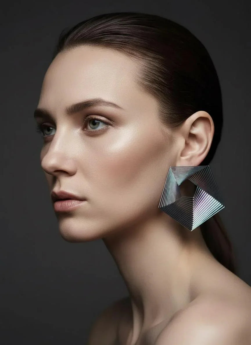 Woman wearing large geometric statement earring, modern minimalist jewelry design