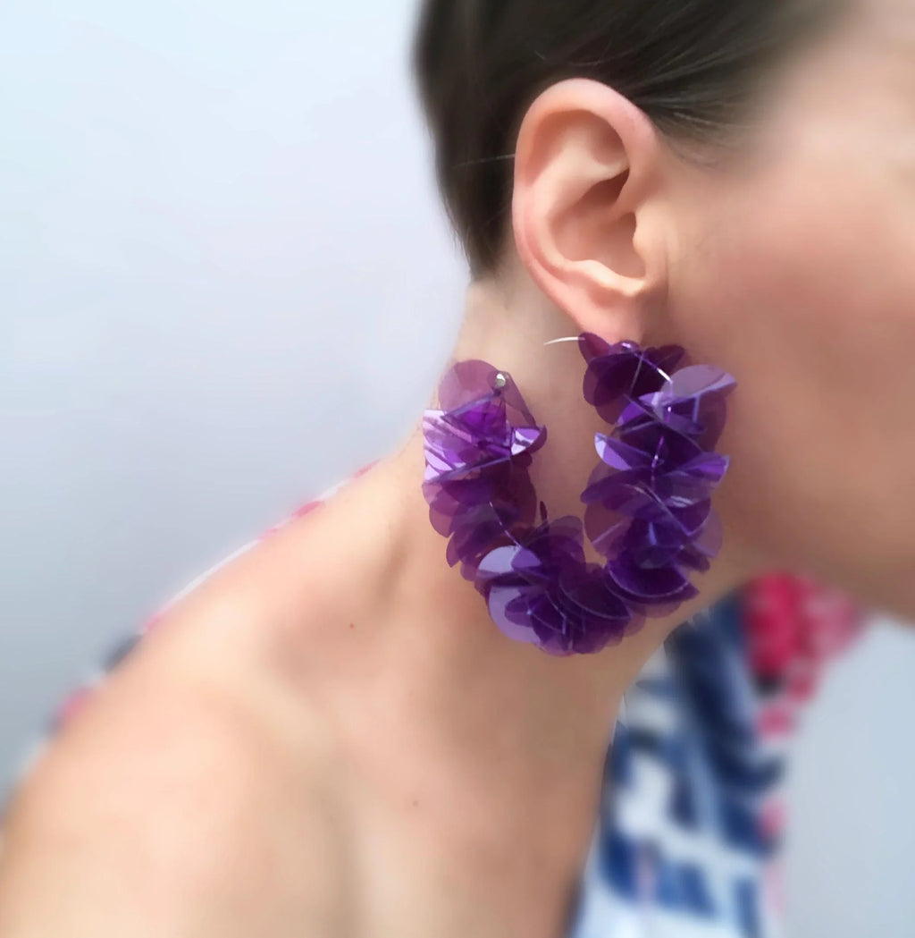 Large purple floral statement earring on woman, contemporary handmade jewelry
