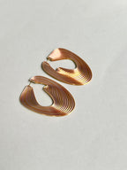 Pink metallic optical art earrings for women